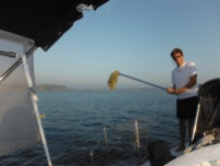 Approaching Tenacatita - Will does a morning mop wiith the dew that settles on the decks